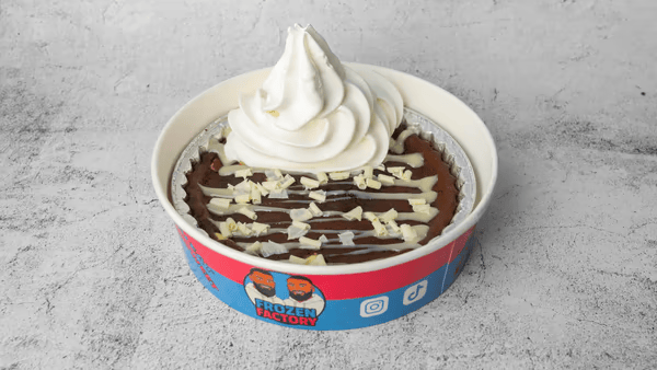 Loaded cookie dough dessert with chocolate drizzle and soft serve
